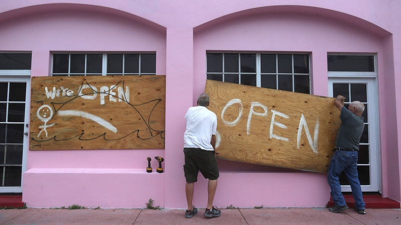 Kevin Forde (L) and John Haughey put up plywood on a window as they prepare for Hurricane Matthew as it approaches the area on October 6, 2016 in Miami Beach, United States. The hurricane is expected to make landfall sometime this evening or early in the morning as a category 4 storm. (Image: Getty)